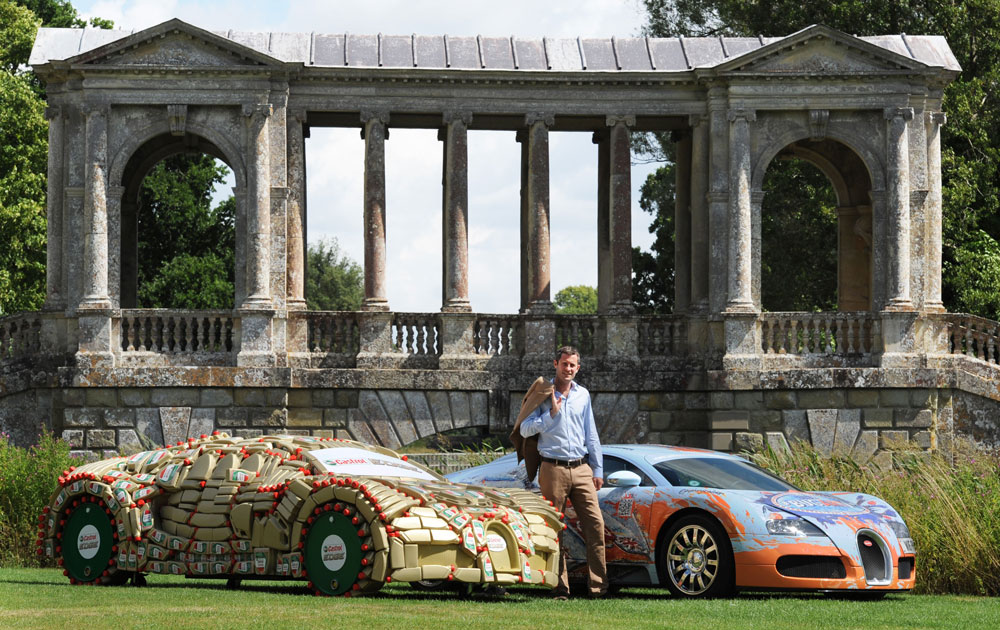 Lord Pembroke, co-founder of the Wilton Classic and Supercars (WCS), stands alongside his Bugatti Veyron and a one-off, life-sized replica of this car made from over 400 Castrol EDGE bottles and barrels, at Wilton House in Salisbury, UK - Ph. Press Association