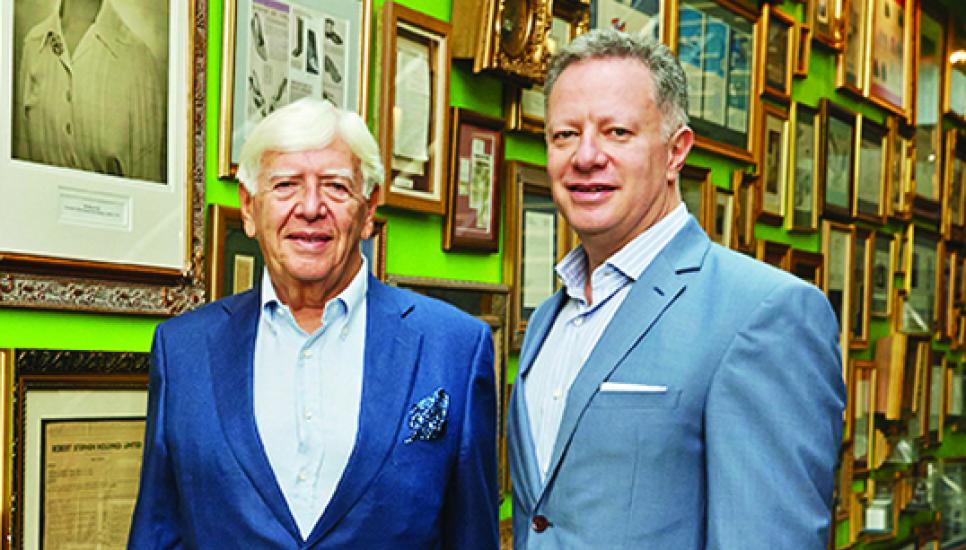 Stephen (left) and Andy Rubin of Pentland Group at their HQ in London in front of portraits of the founders