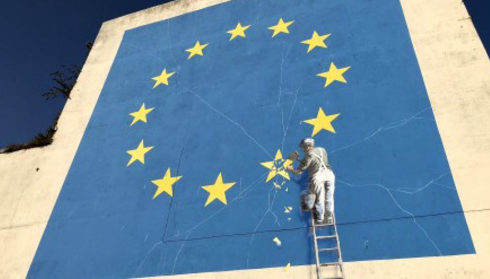 Banksy's mural of a workman chiselling at a star in the European Union flag on the wall of a building in Dover, England